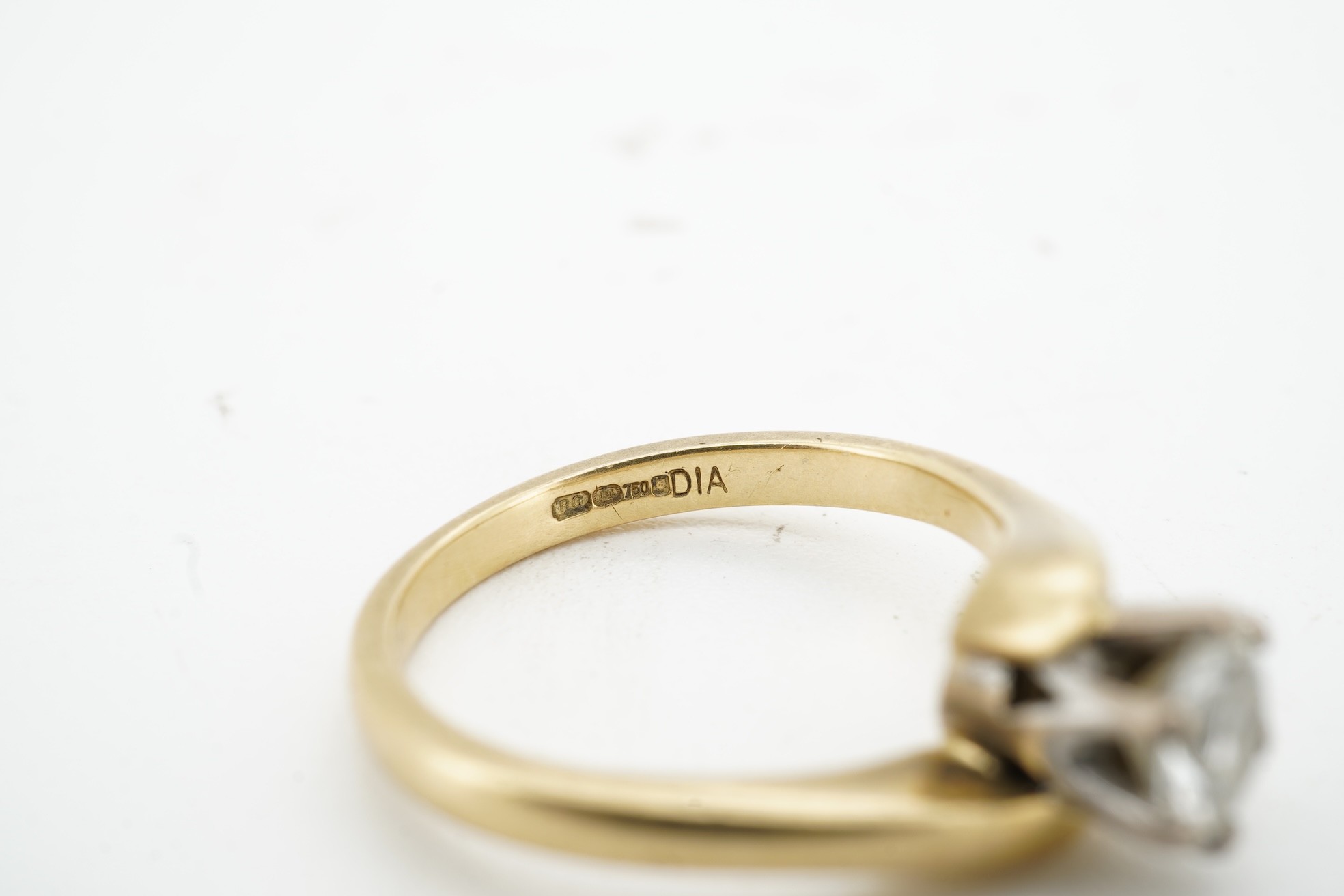 A diamond solitaire ring, claw-set with a brilliant-cut diamond weighing approximately 0.50 carats, to an symmetrical 18ct gold mount, size I, British hallmarks, gross weight approximately 3 grams